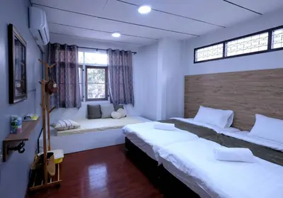 a bedroom with a large bed and a window at 138 White Villa in Bangkok