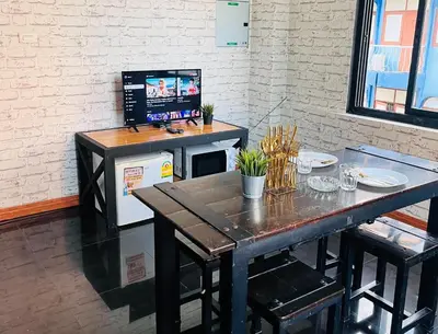 a table with a computer on top of it at Baan33 check in by yourself code inbox 4fl behind Amazon cafe in Bangkok