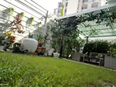 a garden with potted plants and a greenhouse at TEAK VILLA in Bangna
