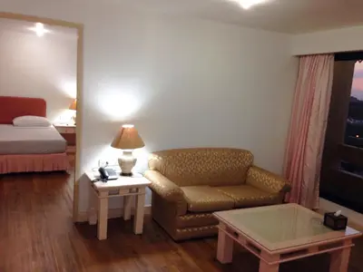 a hotel room with a couch and a bed at LEE PLACE HOTEL in Bangkok