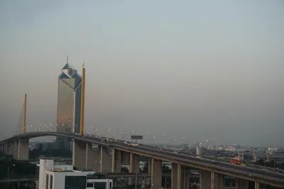 a bridge over a city with a tall building at LEE PLACE HOTEL in Bangkok