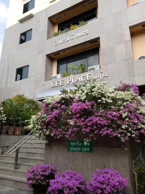 a building with lots of purple and white flowers at LEE PLACE HOTEL in Bangkok