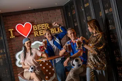 a group of people posing for a picture with beer at Holiday Inn Bangkok by IHG in Bangkok