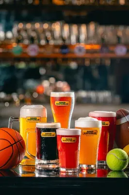 a group of four glasses of beer and a basketball at Holiday Inn Bangkok by IHG in Bangkok