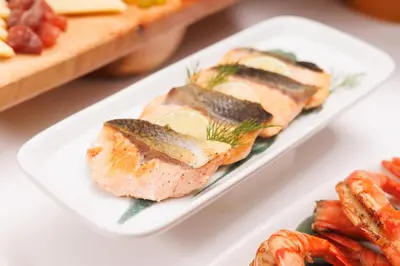 two white plates of food with meat and vegetables at Holiday Inn Bangkok by IHG in Bangkok