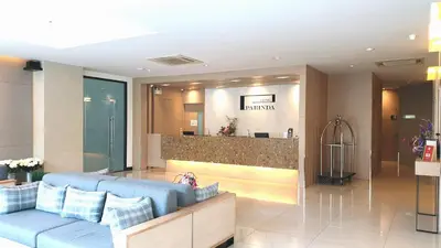 a lobby of a hotel with a blue couch at Parinda Hotel in Bangkok