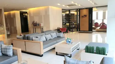 a living room with a couch and a table at Parinda Hotel in Bangkok