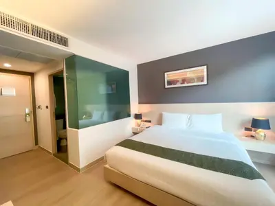 a bedroom with a large bed and a bathroom at iCheck inn Nana by Aspira in Bangkok