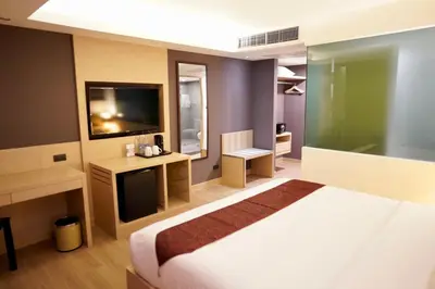 a hotel room with a bed and a television at iCheck inn Nana by Aspira in Bangkok