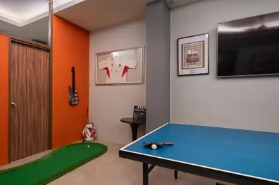 a room with a ping pong table in a room at iCheck inn Gems Center Silom in Bangkok