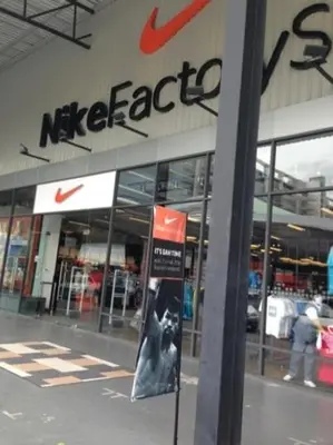 a nike store with a sign in front of it at Deluxe at Popular Condo in Bangkok
