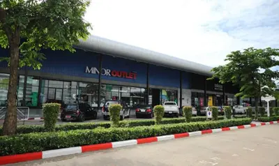 a building with cars parked in a parking lot at Deluxe at Popular Condo in Bangkok