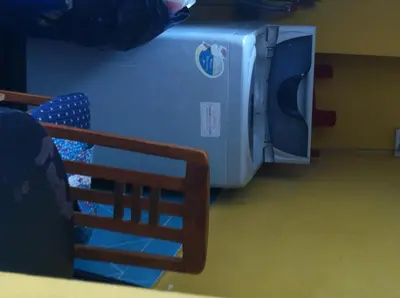 a blue washer and dryer sitting in a room at Orchid Place in Bangkok
