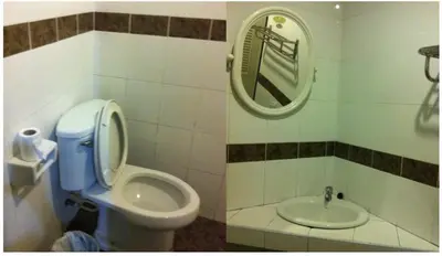 a bathroom with a toilet and a sink at Orchid Place in Bangkok