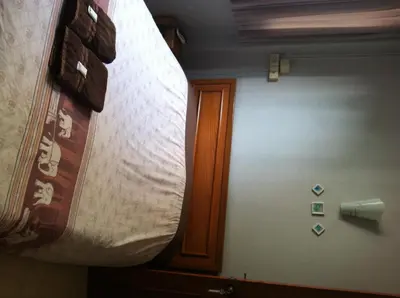 a large mattress hanging from a wall in a room at Orchid Place in Bangkok