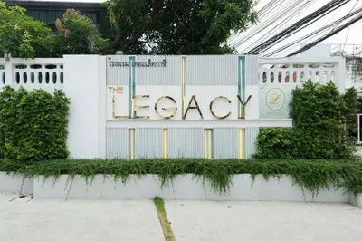 a white fence with a sign that reads legacy at The Legacy Convention Hotel in Nonthaburi