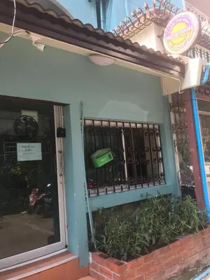 a front door of a building with a fence and plants at Orchid House in Bangkok