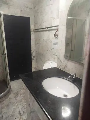 a bathroom with a black sink and a mirror at Orchid House in Bangkok