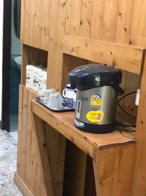 a slow cooker sitting on a wooden table at Orchid House in Bangkok