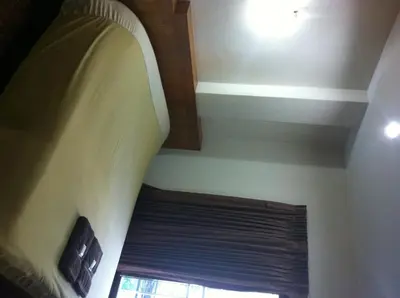 a ceiling with a window and a window blinds at White Orchid Inn II in Bangkok
