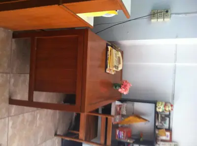 a wooden cabinet hanging on a wall at White Orchid Inn I in Bangkok