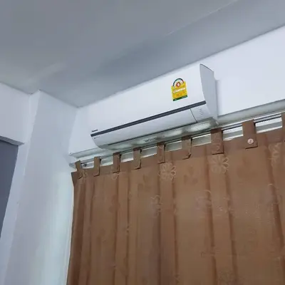 a bathroom with a shower curtain and a dvd at Oblique Apartment - ออฟบลิค อพาร์ทเมนท์ in Nonthaburi