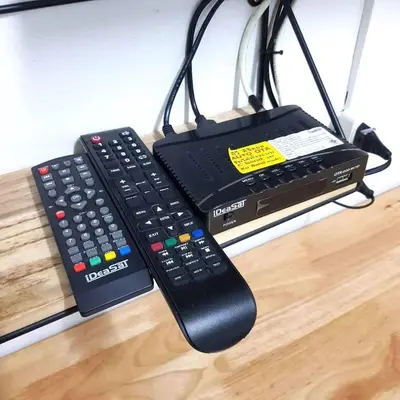 two remote controls sitting on a table next to a remote controller at Oblique Apartment - ออฟบลิค อพาร์ทเมนท์ in Nonthaburi