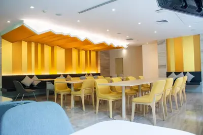 a dining room with tables and yellow chairs at Tango Vibrant Living Hotel - SHA Extra Plus in Bangkok