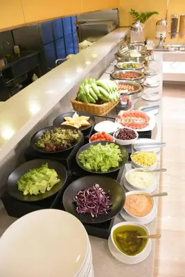 a buffet line with bowls of different types of food at Tango Vibrant Living Hotel - SHA Extra Plus in Bangkok
