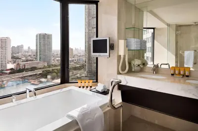 a bathroom with a large tub and a large window at Shangri-La Bangkok in Bangkok