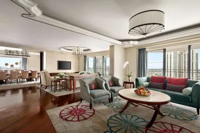 a living room with a couch and a table at Shangri-La Bangkok in Bangkok