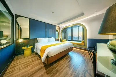 a hotel room with a bed and a window at Graph Hotels Bangkok in Bangkok