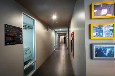 a hallway in a hospital with a sign on the wall at Lemontea Hotel Bangkok in Bangkok