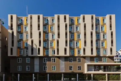a tall apartment building with many windows at Lemontea Hotel Bangkok in Bangkok