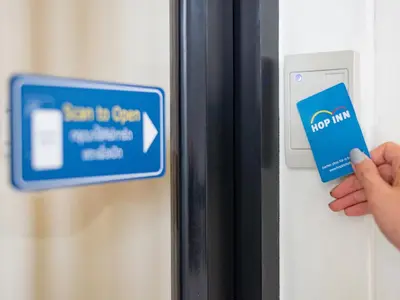 a person unlocking a door with a credit card at HOP INN Chaengwattana in Nonthaburi