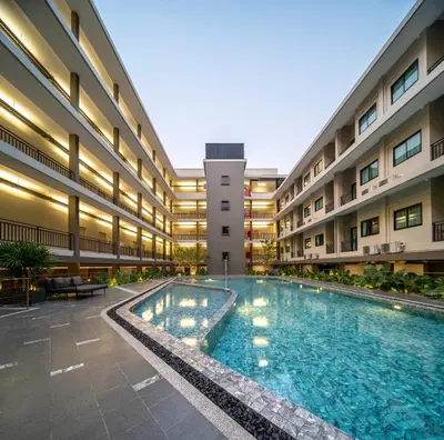 a swimming pool in the middle of a building at College Haus Rangnam in Bangkok