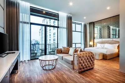 a hotel room with a bed and a couch at The Grand Sala Thai in Bangkok