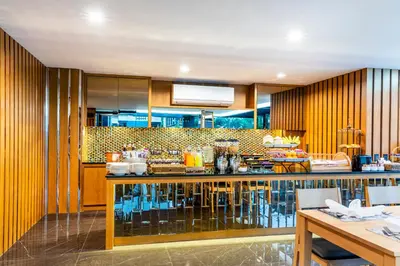 a kitchen with wooden cabinets and a counter top at The Grand Sala Thai in Bangkok