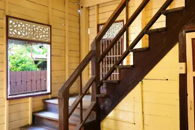 a wooden staircase in a wooden house with a window at Baankhon Private room in Thai house Check in by yourself code inbox Adult Only in Bangkok