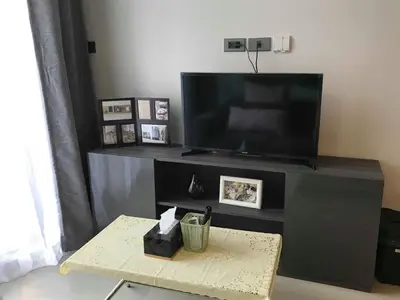 a flat screen tv on a stand with a coffee table at CBD Asoke/Nana/Ploenchit +2 mins to Terminal 21 in Bangkok
