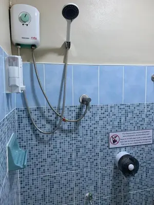 a shower in a bathroom with a shower head at Achcha hotel - itsaraphap MRT station - Wat Arun in Bangkok
