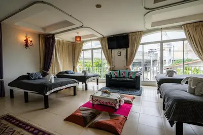 a large living room with couches and a tv at Baan Anodat in Ban Bang Phai