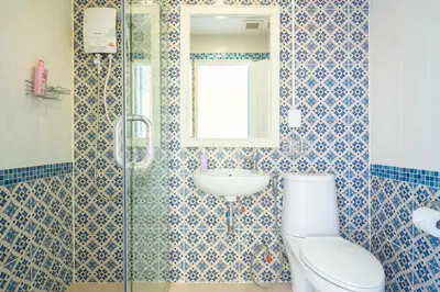 a bathroom with a toilet and a sink at Baan Anodat in Ban Bang Phai