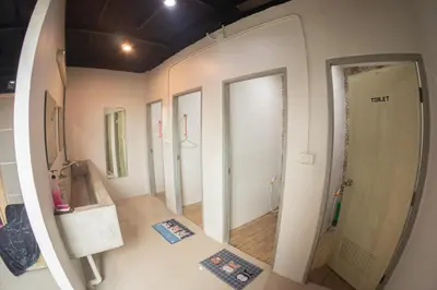 a room with a row of mirrors on the wall at Baan1668 Hometel near Chinatown One Bangkok in Bangkok