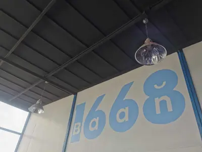 two lights hanging from the ceiling of a barcelona sign at Baan1668 Hometel near Chinatown One Bangkok in Bangkok
