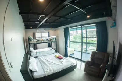 a small room with a bed and a chair at Baan1668 Hometel near Chinatown One Bangkok in Bangkok
