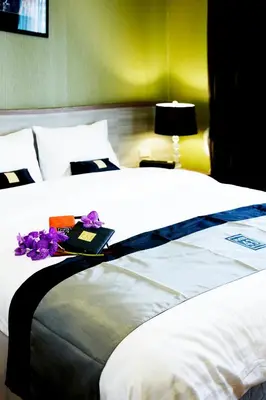 a bedroom with a bed with flowers on it at Poste 43 Residence in Bangkok