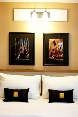 a bedroom with two framed pictures above a bed at Poste 43 Residence in Bangkok