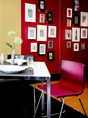 a dining room with a red wall and a table and a red chair at Poste 43 Residence in Bangkok