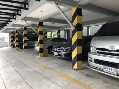 a parking garage with cars parked in it at Petchsiri Boutique Hotel เพชรสิริ บูทิค in Bangkok
